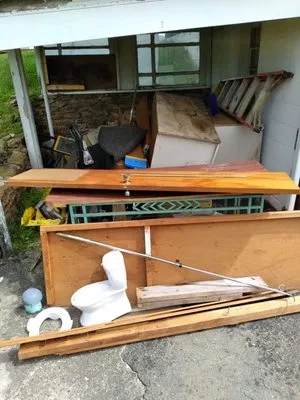 Demolition debris — lumber, fixtures, and materials cleared from a remodel site