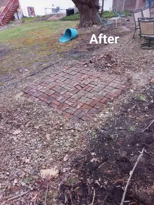 Backyard after hot tub removal — clean brick patio revealed once the hot tub is gone