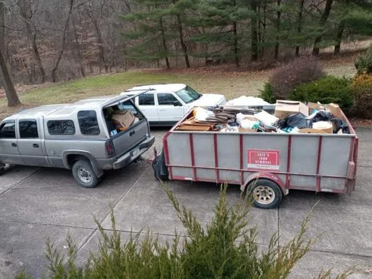 Cree's truck and trailer loaded with junk from a property cleanout in Derry, PA